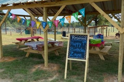 a group of lawn chairs sitting on top of a grass covered field