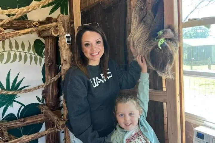 a little girl standing in front of a door