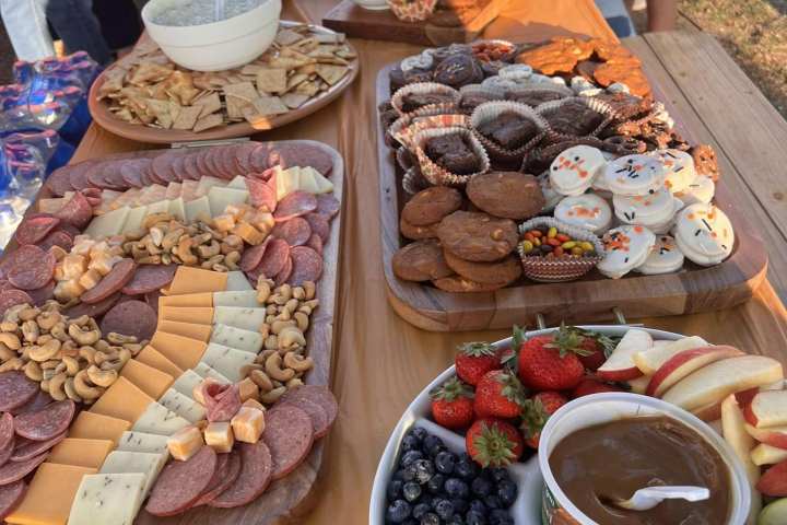 a group of people sitting at a table with a plate of food